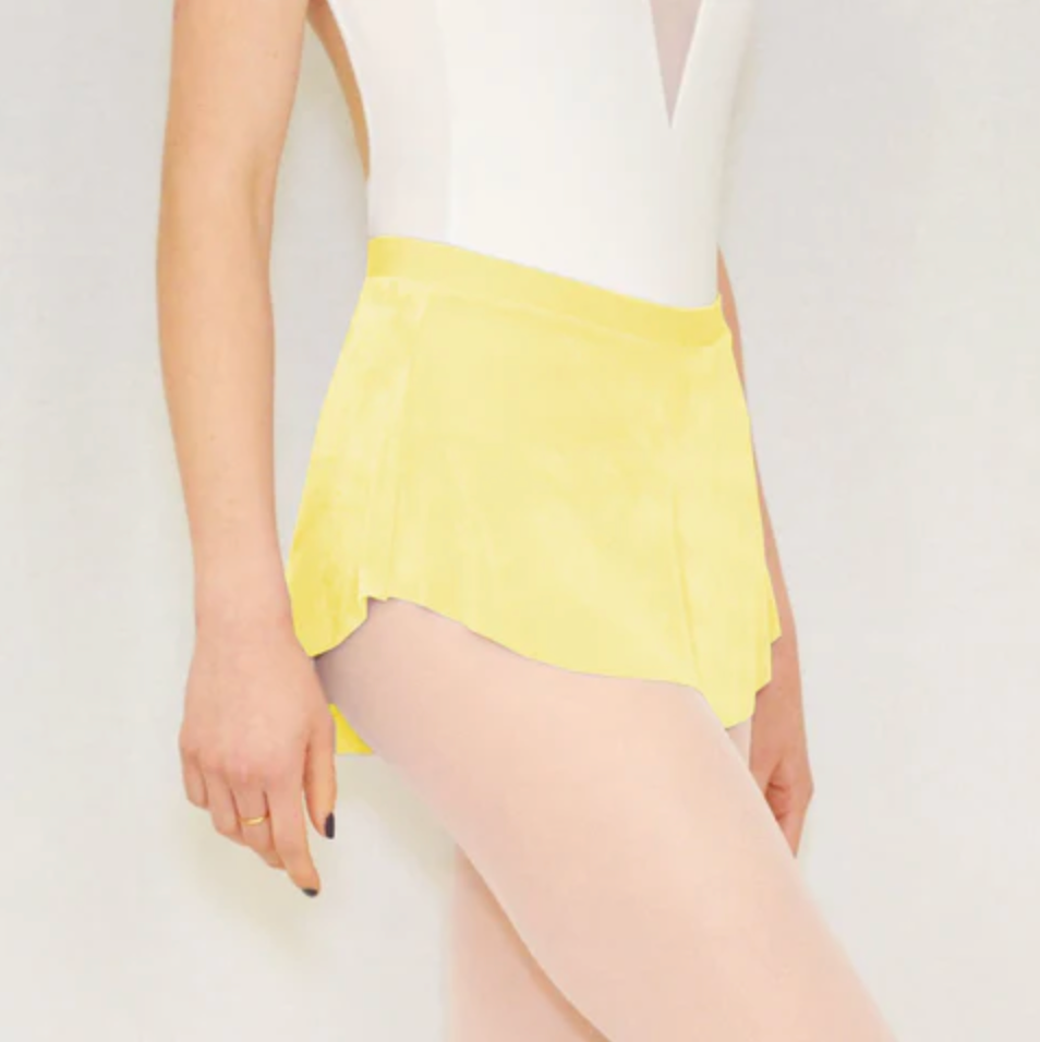A ballerina wears a bright yellow flowy Bullet Pointe ballet skirt.