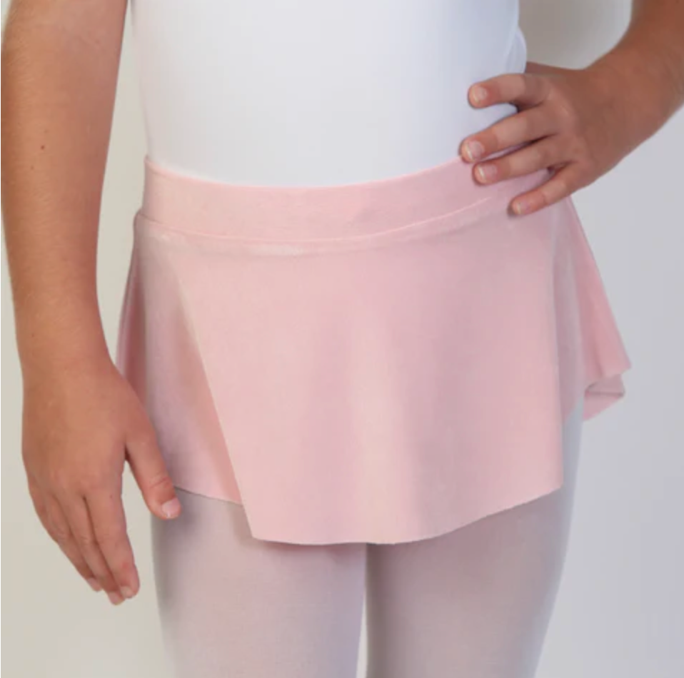 A young ballerina wears a soft, light pink flowy Bullet Pointe ballet skirt.