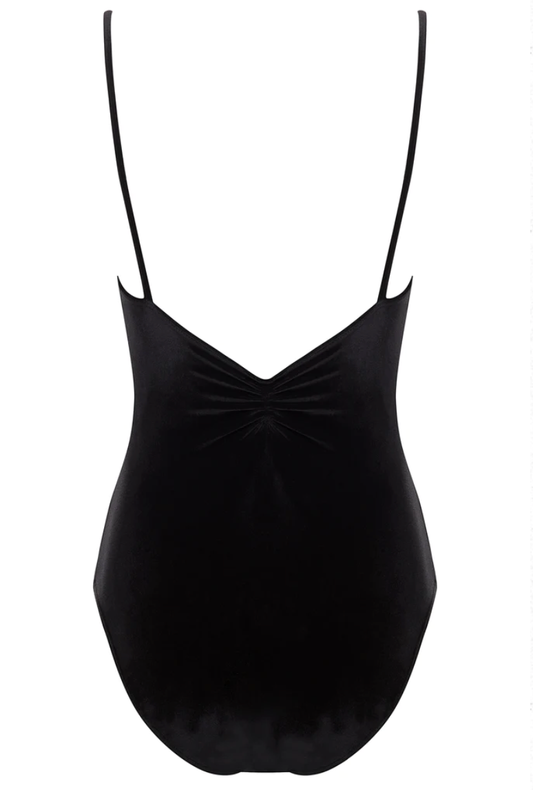 The back of a black leotard, with a pinch detail at the center of the back and spaghetti straps.
