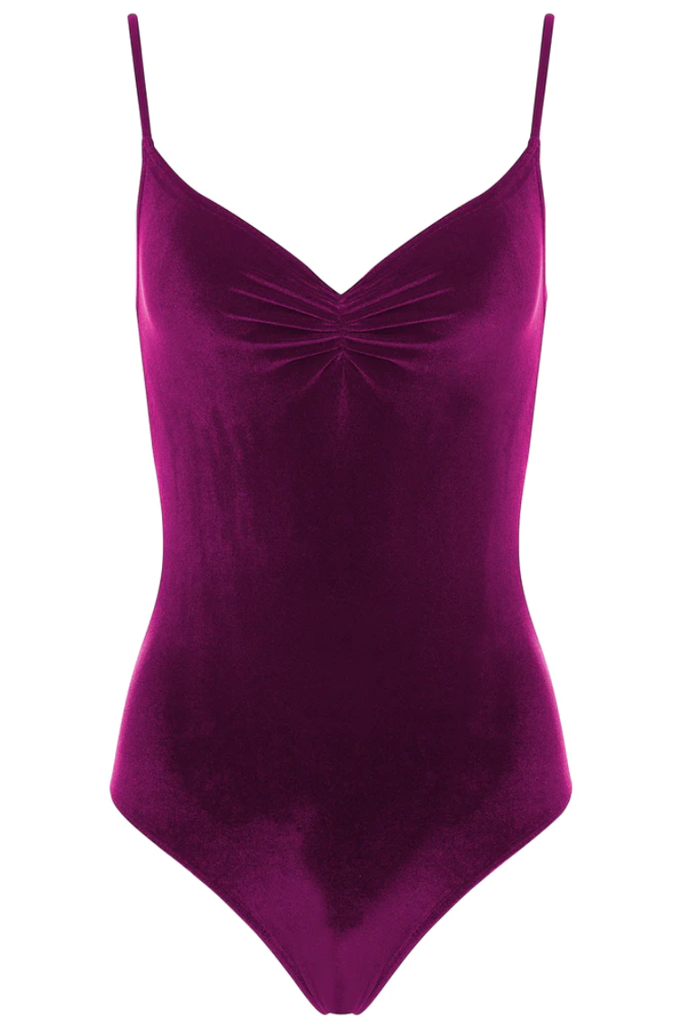 A deep raspberry colored velvet leotard with a v-neck pinch front detail and spaghetti straps.