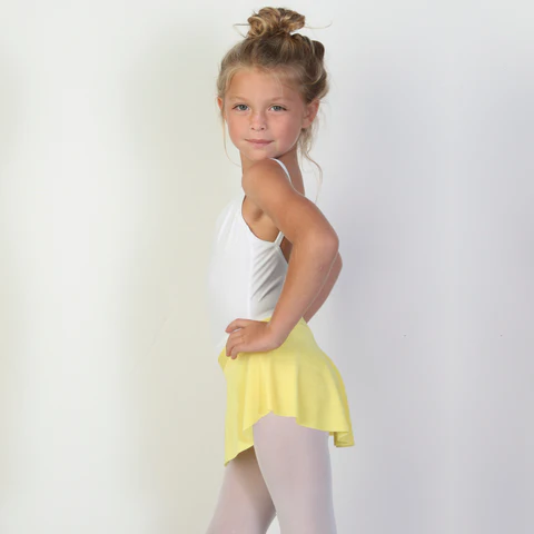 A young ballerina wears a bright yellow flowy Bullet Pointe ballet skirt.