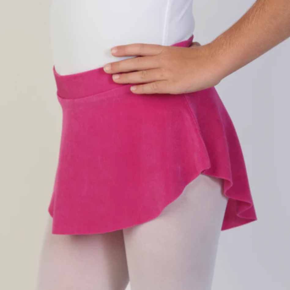 A young ballerina wears a deep pink flowy Bullet Pointe ballet skirt. 