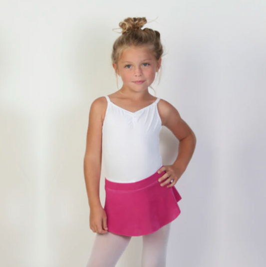 A young ballerina wears a deep pink flowy Bullet Pointe ballet skirt. 
